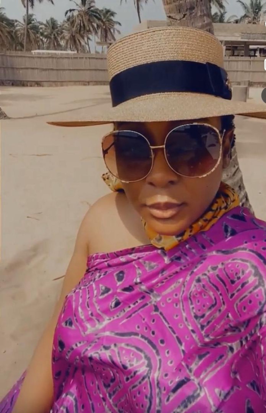 Aisha on the beach in a straw hat