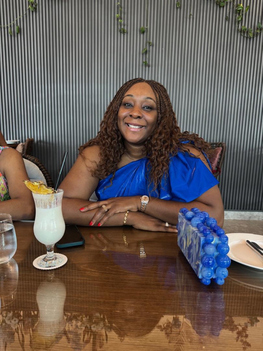 Aisha at lunch with a piña colada