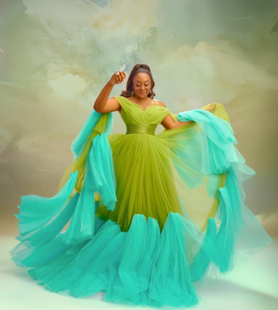 Aisha in a green and turquoise tulle gown in full swirl
